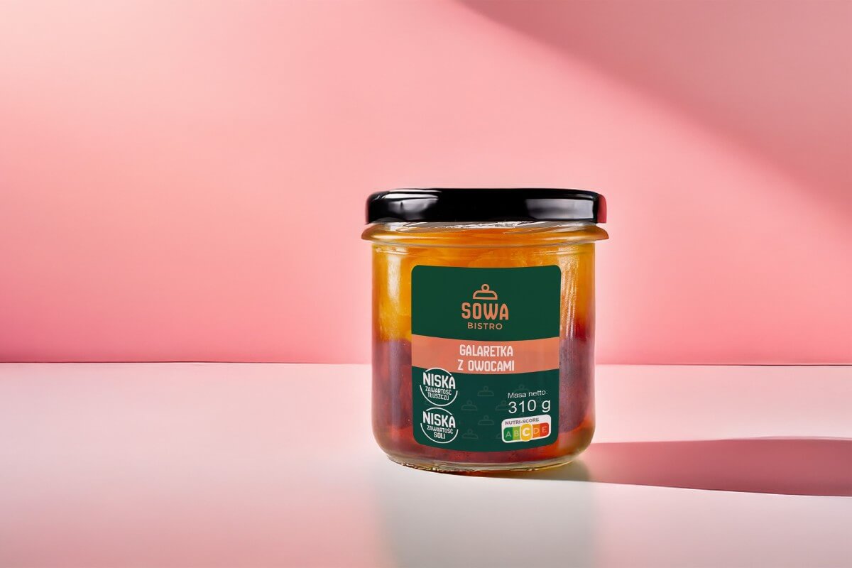 Słoik produktu Sowa Bistro – galaretka z owocami o masie 310 g, na różowym tle, z etykietą informującą o niskiej zawartości tłuszczu i soli oraz oznaczeniem Nutri-Score.